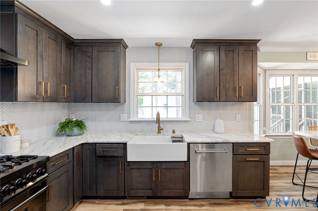 4427 Tweedsmuir Court, Midlothian, VA 23120 Kitchen featuring dark wood cabinetry, white stone-finish countertops, herringbone-pattern tile backsplash, farmhouse-style apron sink, and stainless steel dishwasher
