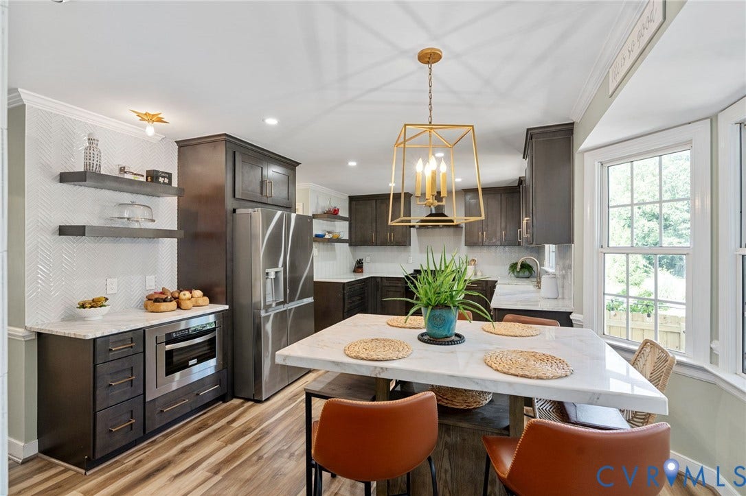 4427 Tweedsmuir Court, Midlothian, VA 23120 Kitchen featuring dark wood cabinetry, stainless steel appliances, stone countertops, herringbone patterned wall tile, and geometric pendant lighting