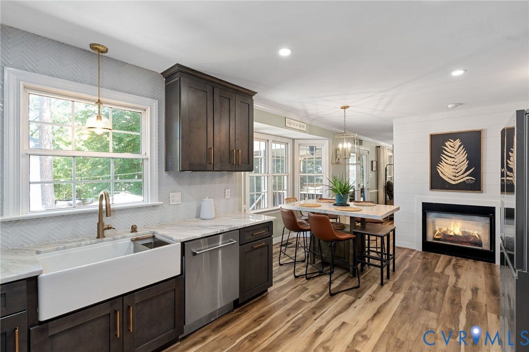 4427 Tweedsmuir Court, Midlothian, VA 23120 Kitchen featuring dark cabinetry, farmhouse sink, stone countertops, wood-finish flooring, and built-in fireplace
