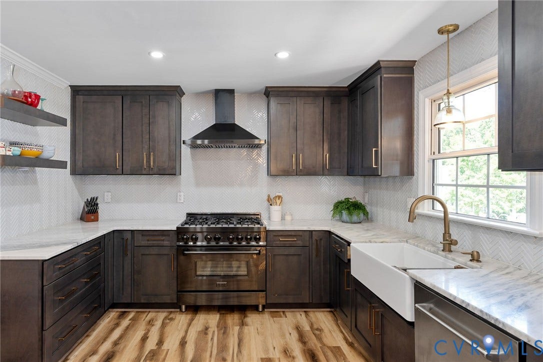 4427 Tweedsmuir Court, Midlothian, VA 23120 Kitchen featuring dark-stained cabinetry, herringbone-patterned tile backsplash, apron-front farmhouse sink with brass-finish faucet, professional-style gas range, and stone-surface countertops