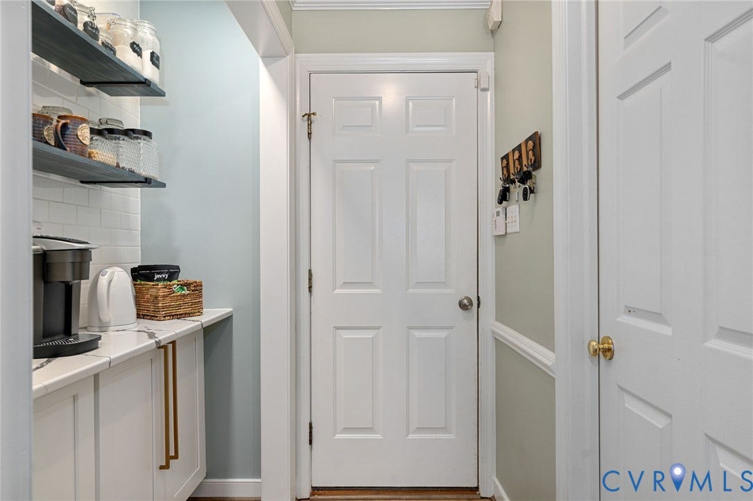4427 Tweedsmuir Court, Midlothian, VA 23120 White cabinetry with gold-tone hardware, quartz countertop, subway tile backsplash, and stained wood floating shelves
