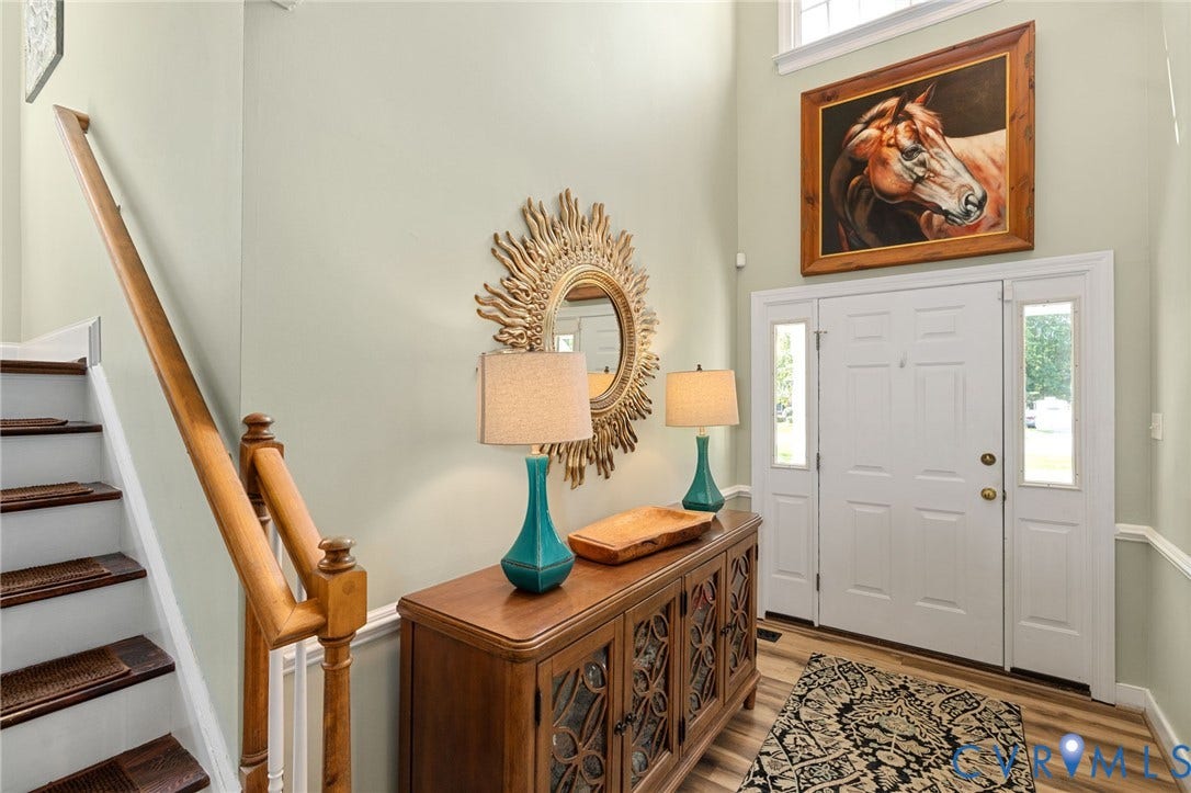 4427 Tweedsmuir Court, Midlothian, VA 23120 Double-height foyer featuring a multi-panel front door with sidelights, a wood-finish staircase with a turned wood railing, and upper-level transom window