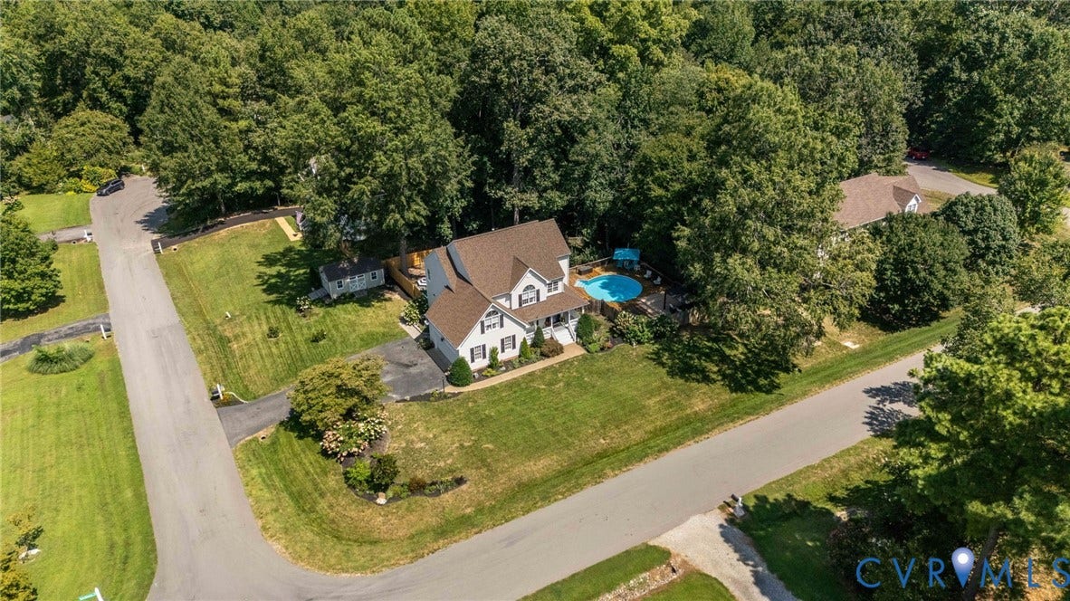 4427 Tweedsmuir Court, Midlothian, VA 23120 Multi-story residence featuring a shingled roof, in-ground swimming pool, asphalt driveway, and expansive lawn surrounded by mature trees
