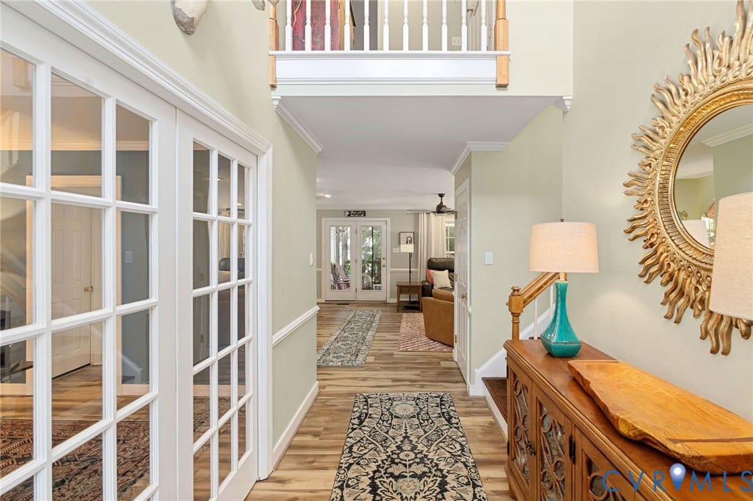 4427 Tweedsmuir Court, Midlothian, VA 23120 Two-story foyer featuring wood-finish flooring, white French doors, wainscoting, and a wooden staircase railing