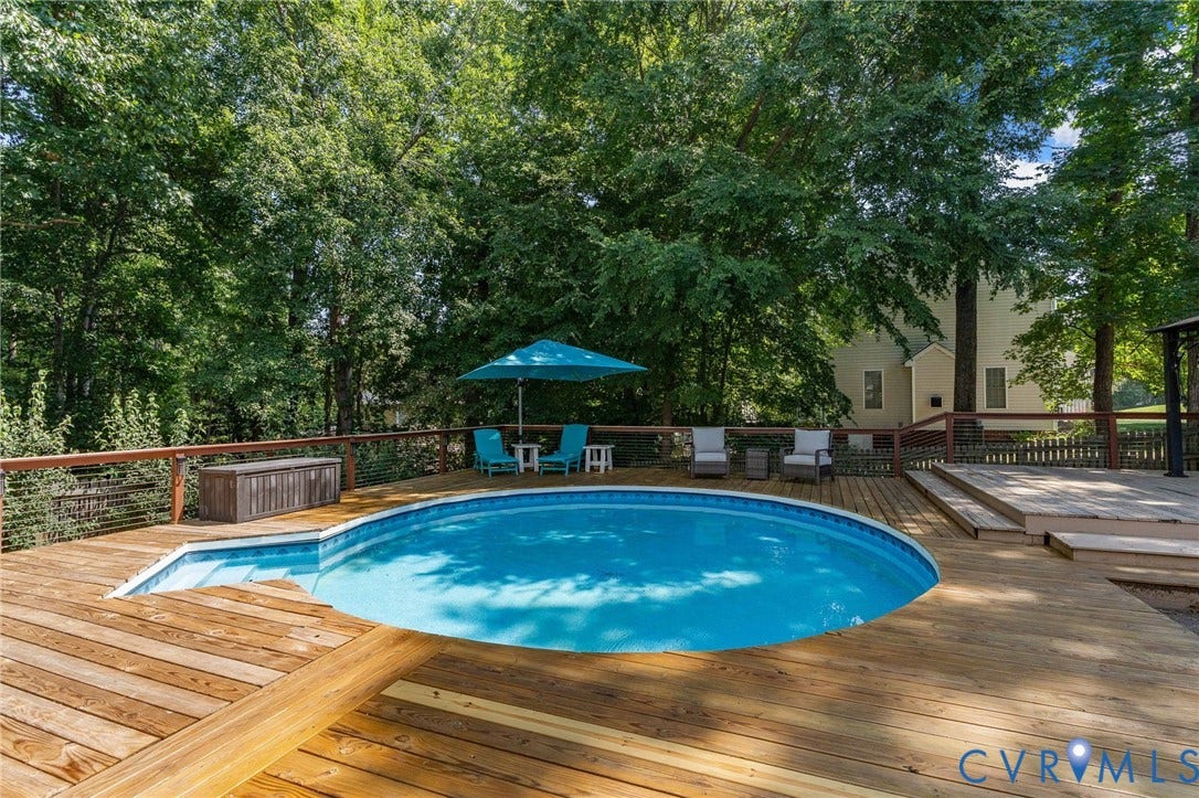 4427 Tweedsmuir Court, Midlothian, VA 23120 Above-ground swimming pool surrounded by tiered wood decking, cable railing system, and mature tree canopy