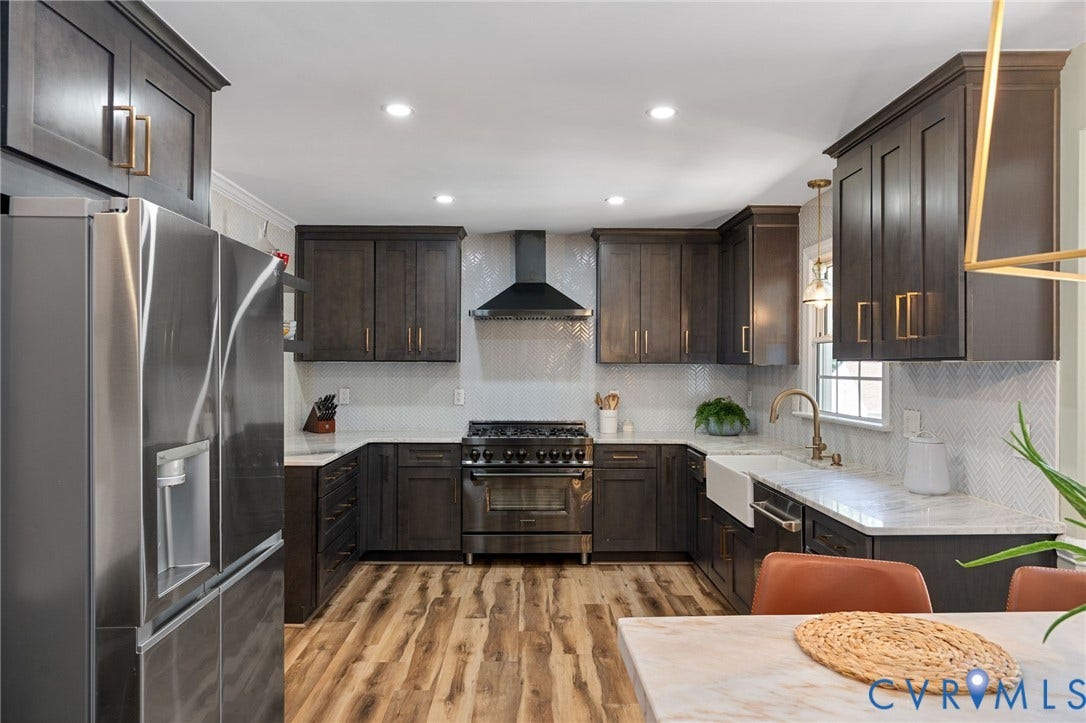 4427 Tweedsmuir Court, Midlothian, VA 23120 Kitchen featuring dark wood cabinetry with gold-tone hardware, a white apron-front sink, quartz countertops, a herringbone-pattern tile backsplash, and wood-finish flooring