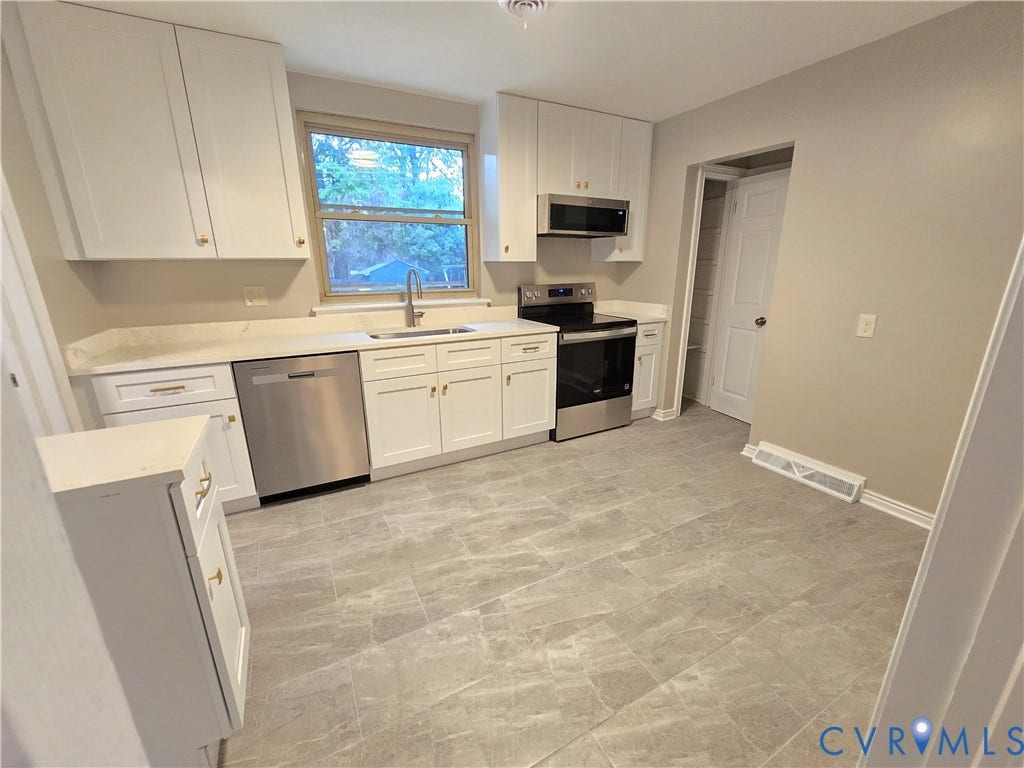 1108 Pierpont Road, Richmond, VA 23225 Kitchen featuring white Shaker-style cabinetry, solid-surface countertops, stone-patterned tile flooring, and stainless steel appliances