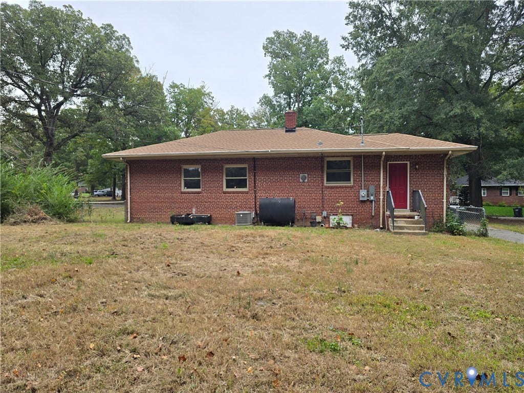 1108 Pierpont Road, Richmond, VA 23225 Red brick exterior featuring a hip roof, chimney, and mature perimeter trees