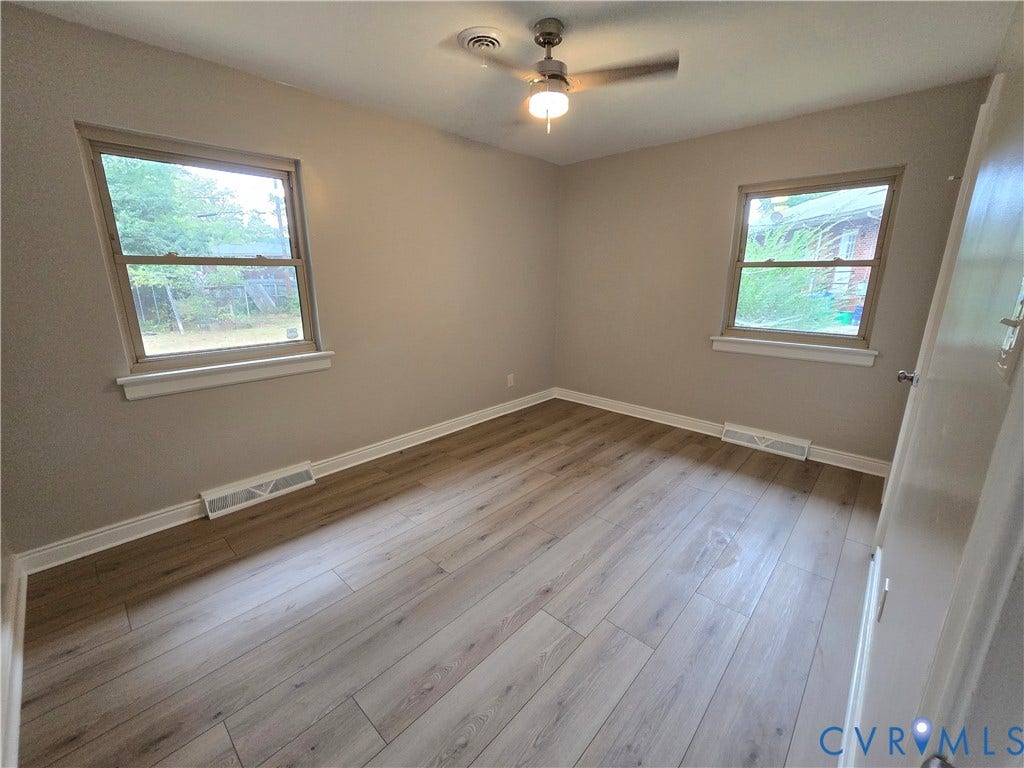 1108 Pierpont Road, Richmond, VA 23225 Bedroom 2 with LVP flooring, two double-hung windows, and a ceiling fan with integrated lighting