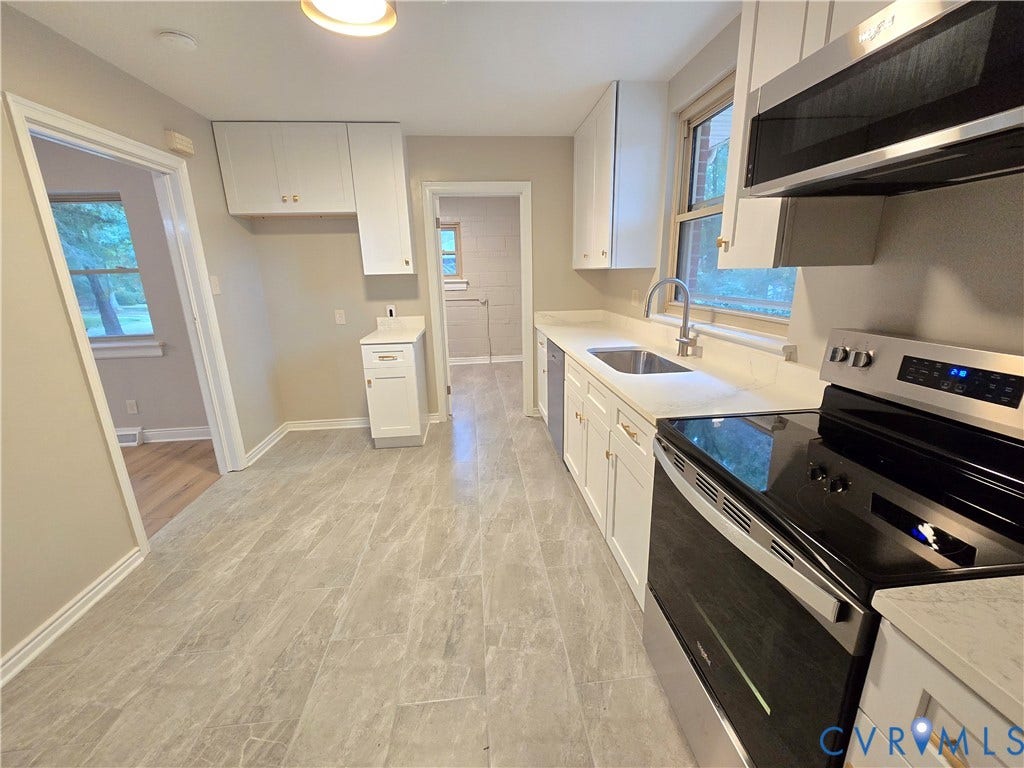 1108 Pierpont Road, Richmond, VA 23225 Kitchen featuring white shaker-style cabinetry, stone-surface countertops, tile flooring, stainless steel appliances, and a double-basin undermount sink