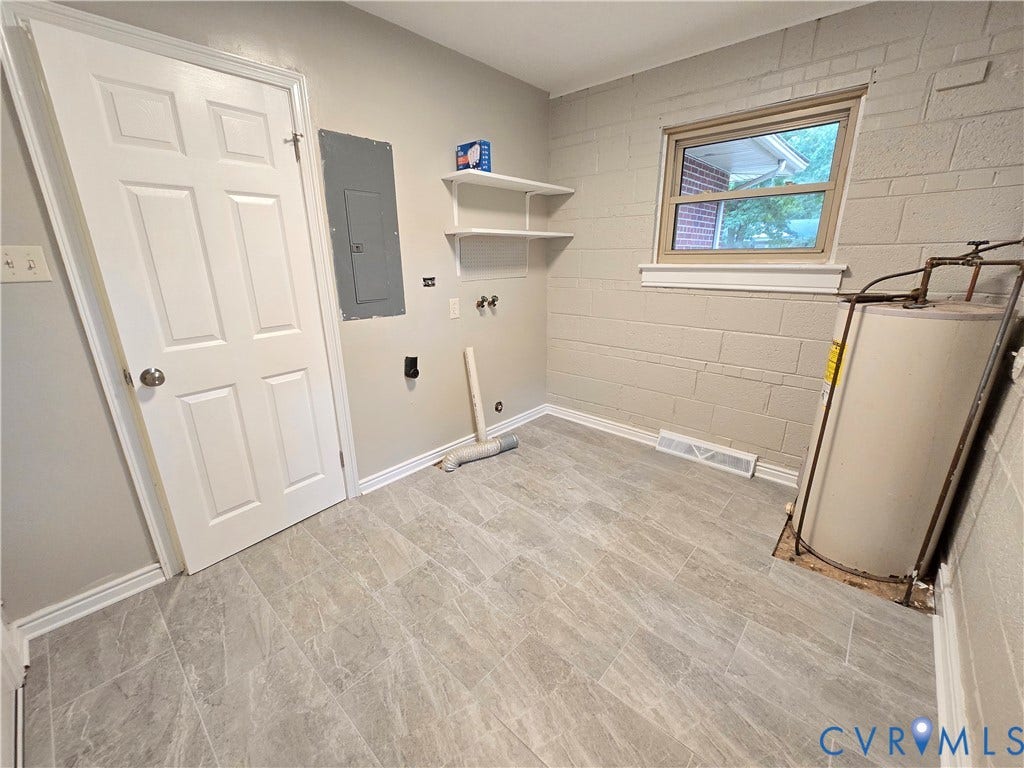 1108 Pierpont Road, Richmond, VA 23225 Utility/Laundry Room featuring tile flooring, painted masonry walls, built-in shelving, and a six-panel door. 200-amp electrical service.