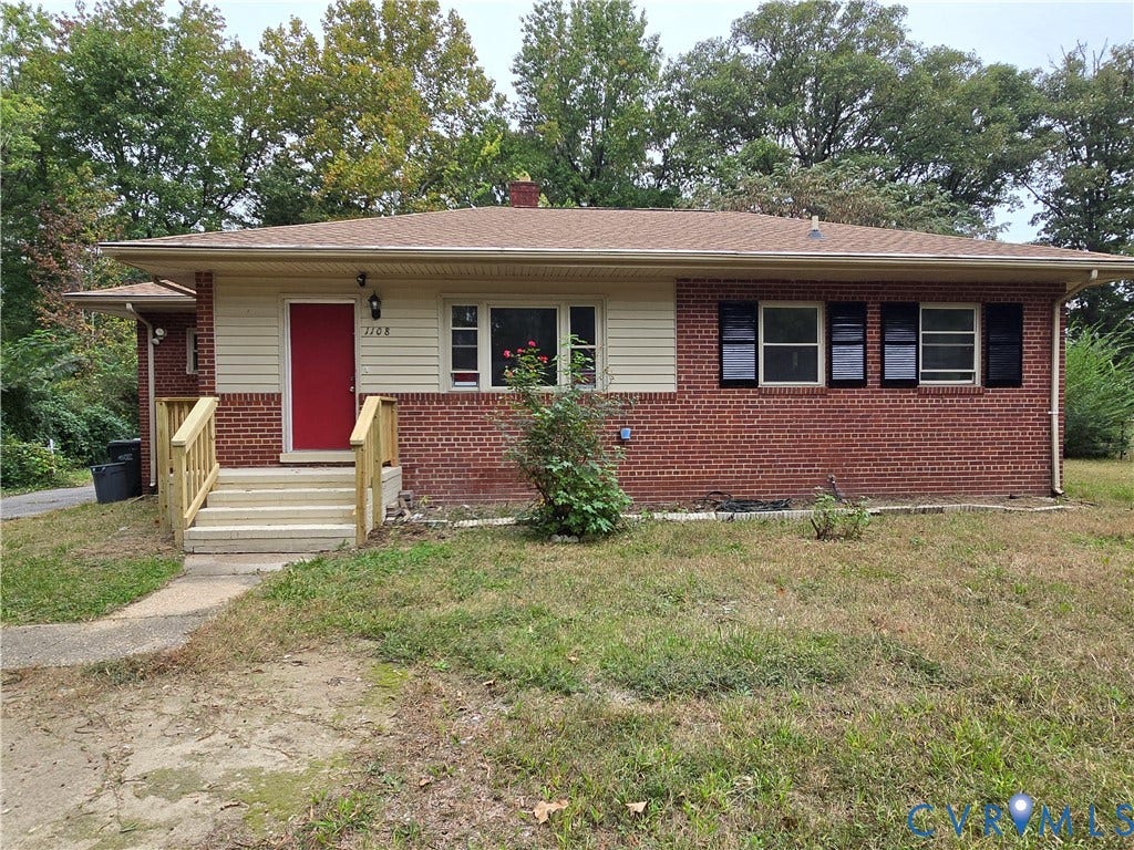 1108 Pierpont Road, Richmond, VA 23225 Single-story exterior featuring red brick masonry, tan horizontal siding, contrasting dark shutters, and a wood-toned entrance staircase