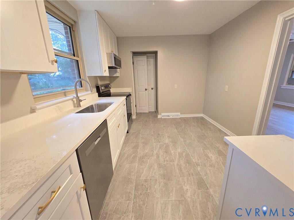1108 Pierpont Road, Richmond, VA 23225 Kitchen featuring white cabinetry, solid surface countertops, stainless steel appliances, a gooseneck faucet, and stone-finish tile flooring