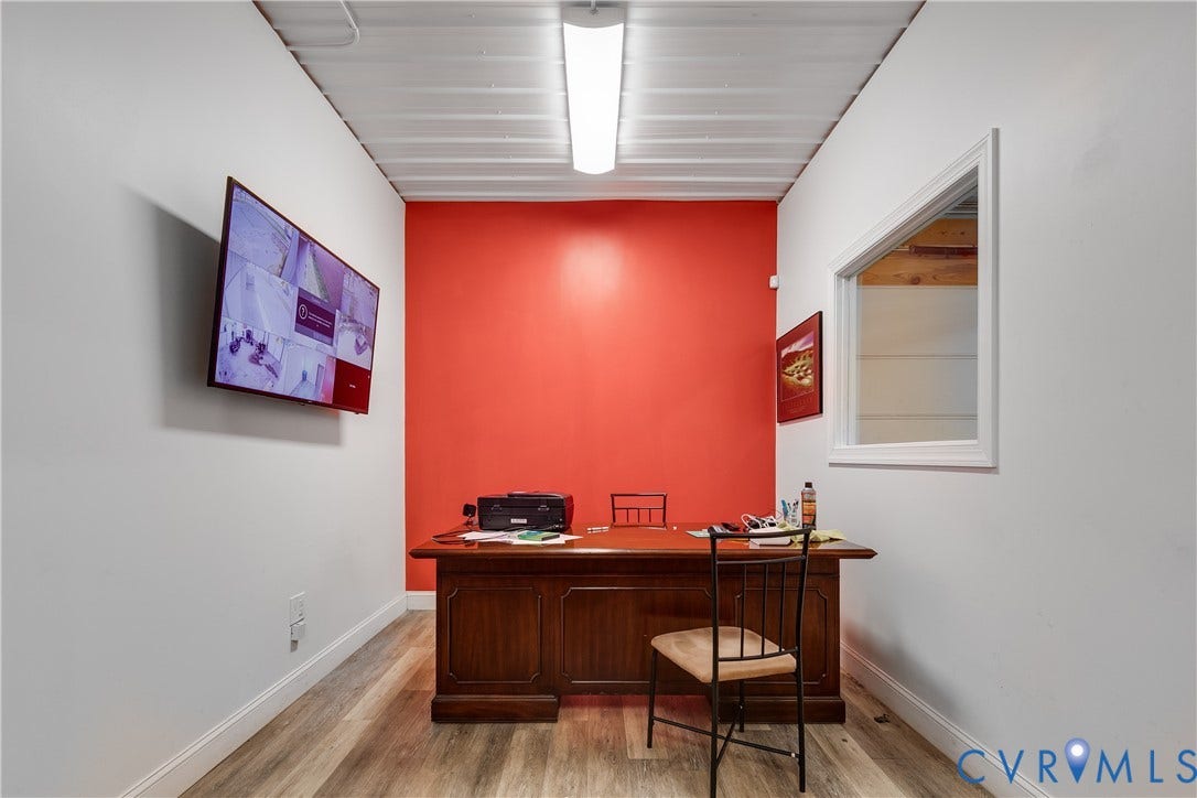 3300 Hull Street, Richmond, VA 23224 Interior space featuring a corrugated metal ceiling, wood-finish flooring, a wall-mounted rectangular window, and a linear fluorescent lighting fixture