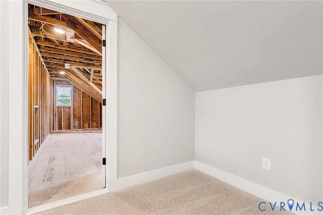 8860 Emily Jane Place, Quinton, VA 23141 A partially finished attic space featuring a window and exposed wooden beams, offering potential for further development