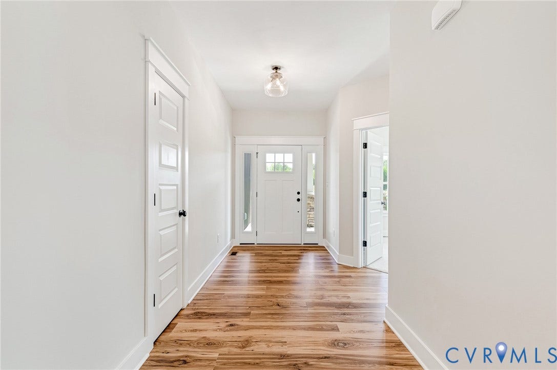 8860 Emily Jane Place, Quinton, VA 23141 Inviting entry hall featuring hardwood floors, white trim, and a white front door with glass panels