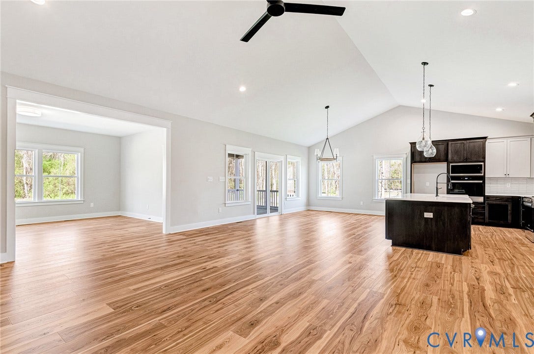 8860 Emily Jane Place, Quinton, VA 23141 This open-concept living space features hardwood flooring and vaulted ceilings with recessed lighting