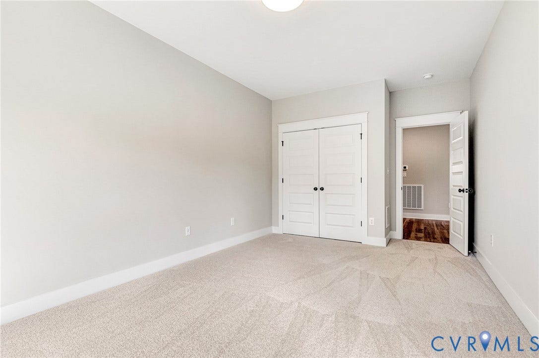 8860 Emily Jane Place, Quinton, VA 23141 This room features light-colored carpeting, neutral painted walls, and white trim throughout