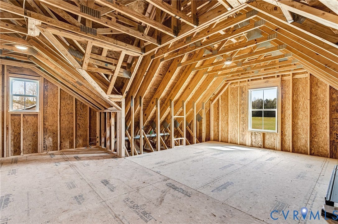 8860 Emily Jane Place, Quinton, VA 23141 The property features an unfinished room with visible wooden framing and subflooring