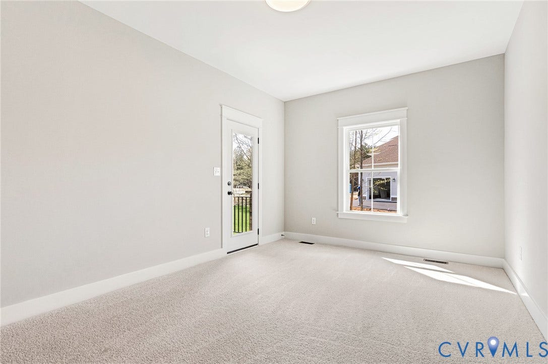 8860 Emily Jane Place, Quinton, VA 23141 Spacious room with light-colored carpet, a large window, and a door leading to an outdoor area
