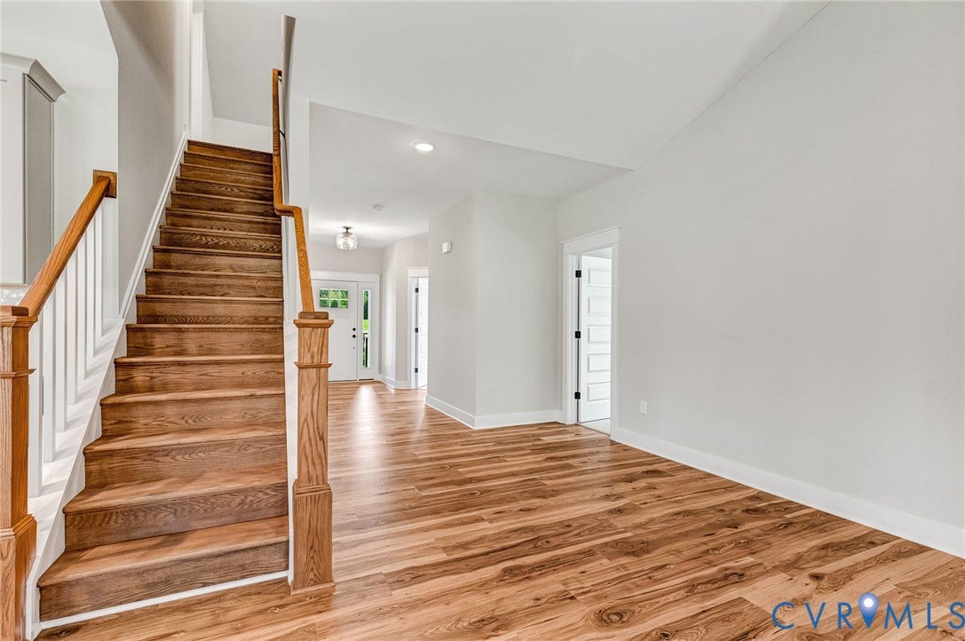 8860 Emily Jane Place, Quinton, VA 23141 Entryway featuring hardwood floors, a wooden staircase with white risers, and white walls
