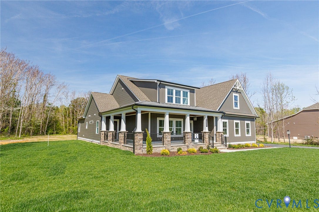 8860 Emily Jane Place, Quinton, VA 23141 The property features a well-maintained lawn and a covered front porch with white pillars and stone accents