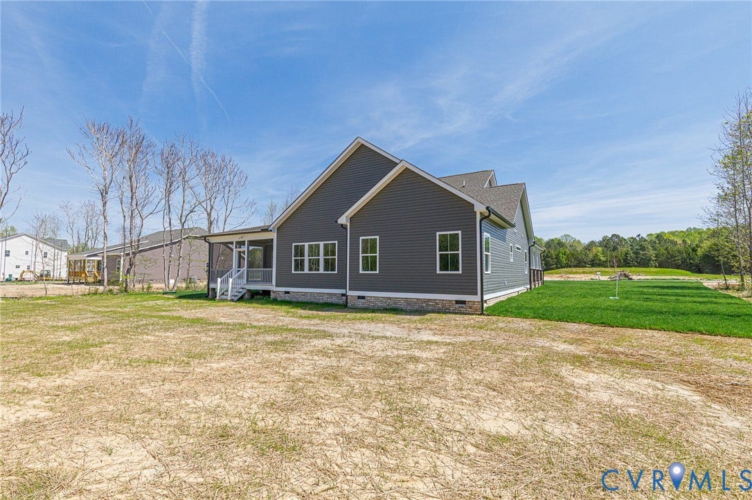 8860 Emily Jane Place, Quinton, VA 23141 The property features a dark gray exterior with light trim windows and a visible covered porch