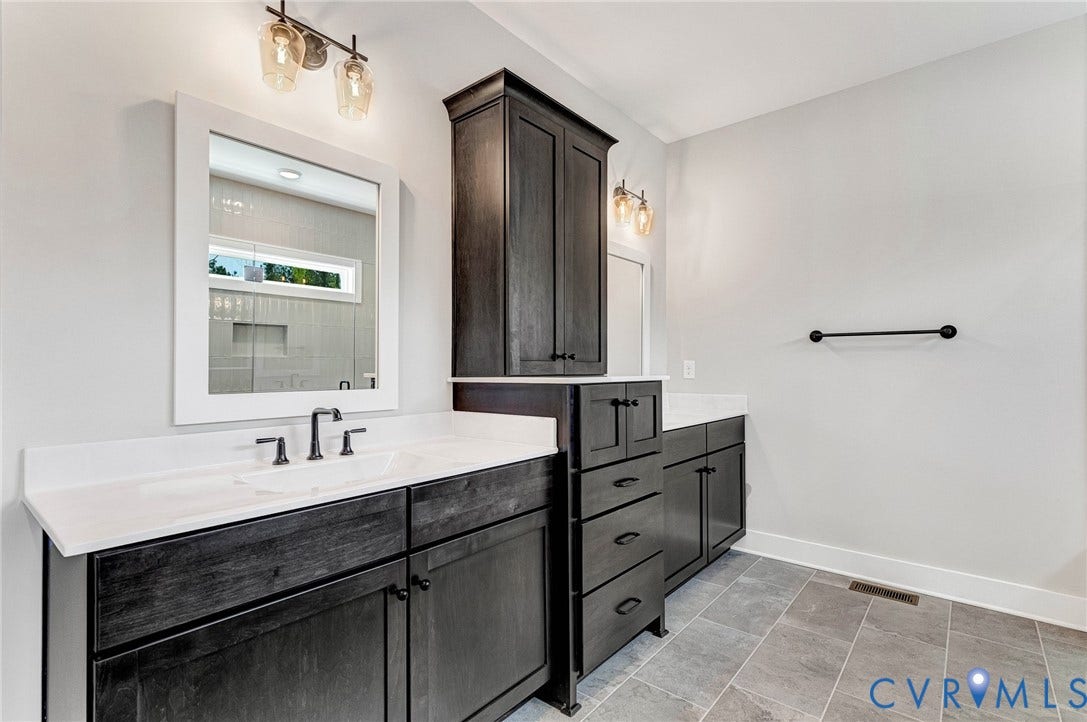 8860 Emily Jane Place, Quinton, VA 23141 Bathroom featuring dual dark wood vanities with white countertops, a tall dark wood storage cabinet, and tiled flooring