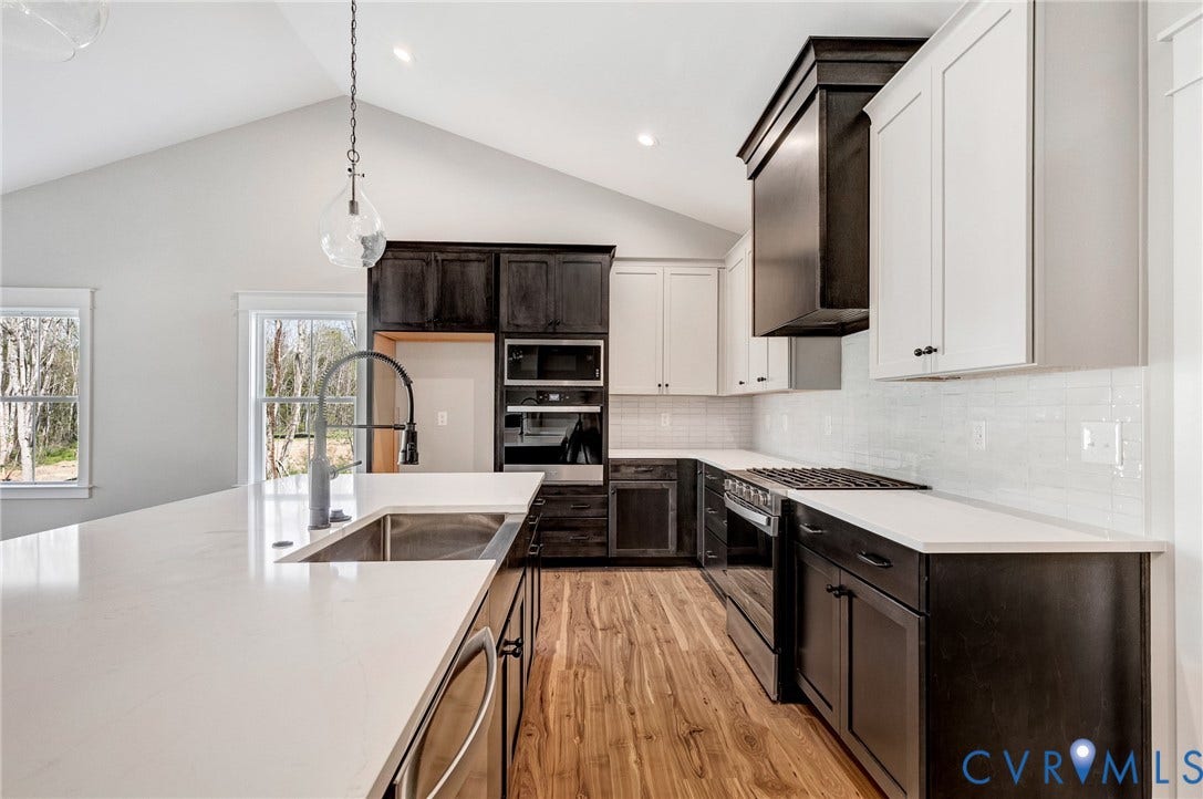 8860 Emily Jane Place, Quinton, VA 23141 Kitchen featuring a vaulted ceiling, recessed lighting, white countertops, wood flooring, and a gas range
