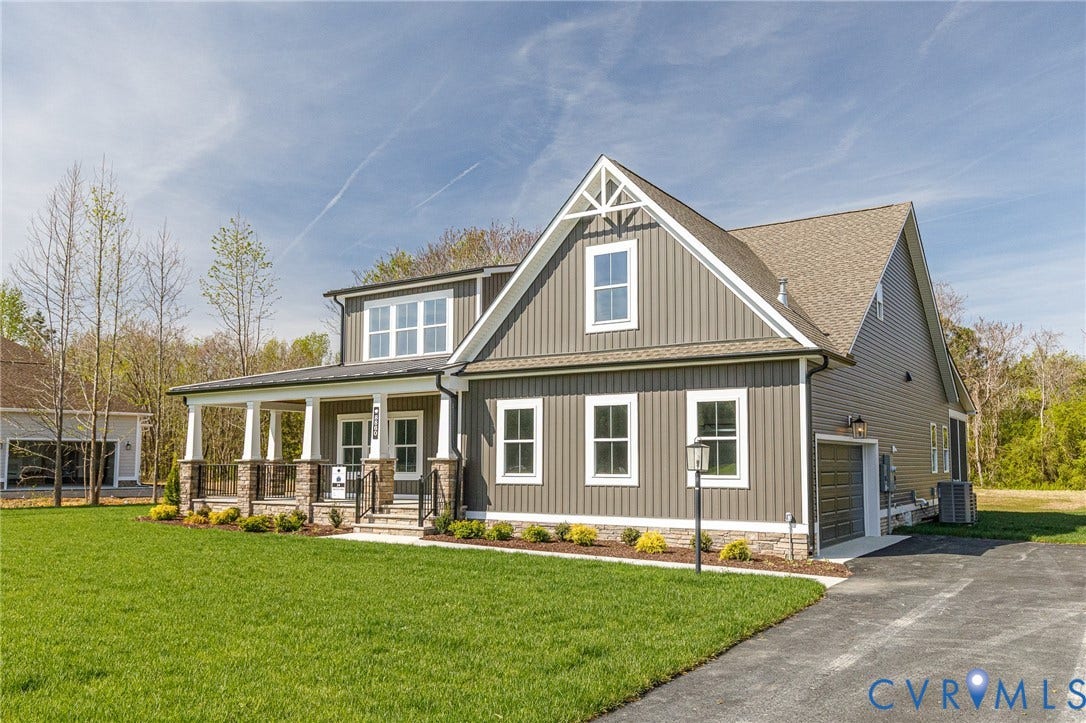 8860 Emily Jane Place, Quinton, VA 23141 The property features a well-maintained lawn, a paved driveway, and an attached garage