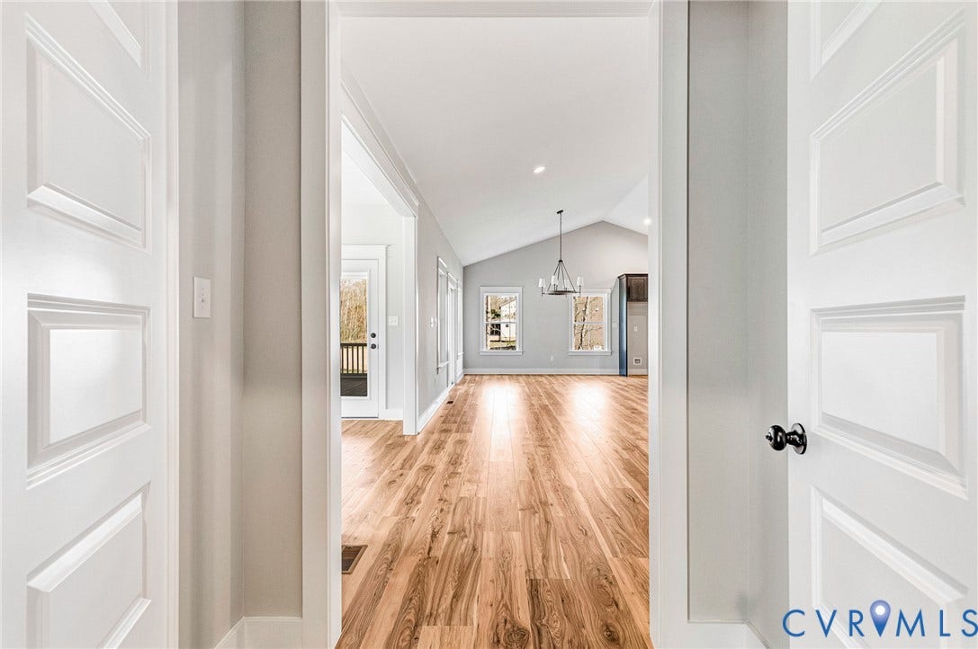 8860 Emily Jane Place, Quinton, VA 23141 The property features hardwood floors, vaulted ceilings, and a decorative chandelier, creating an inviting atmosphere