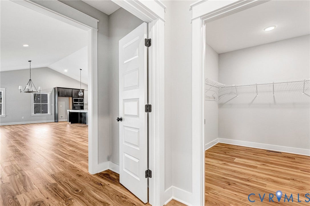 8860 Emily Jane Place, Quinton, VA 23141 This property features wood flooring throughout, white interior doors, and a spacious closet with wire shelving
