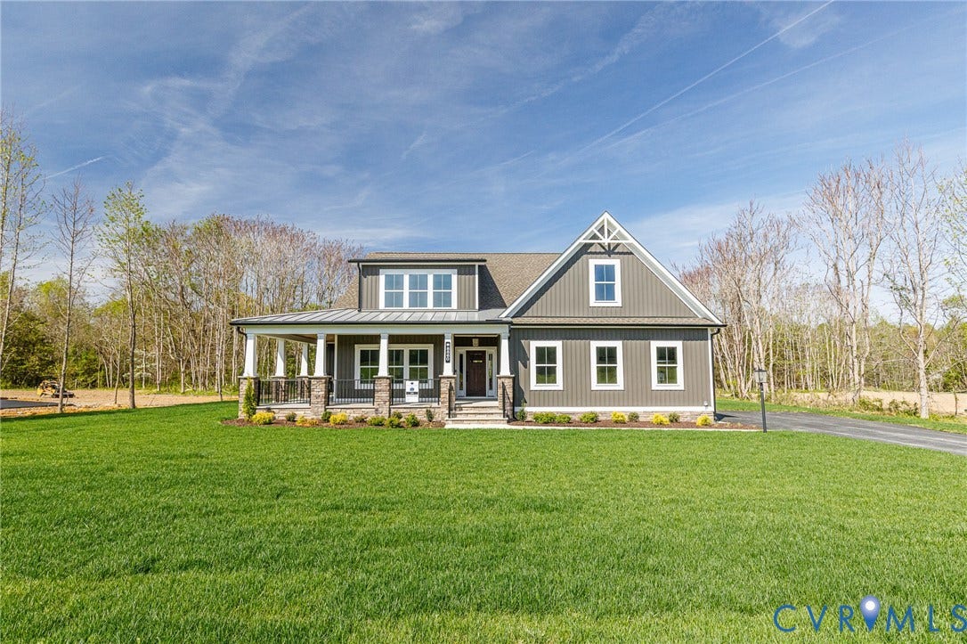 8860 Emily Jane Place, Quinton, VA 23141 This property features a well-maintained lawn and a welcoming covered porch with stone column bases