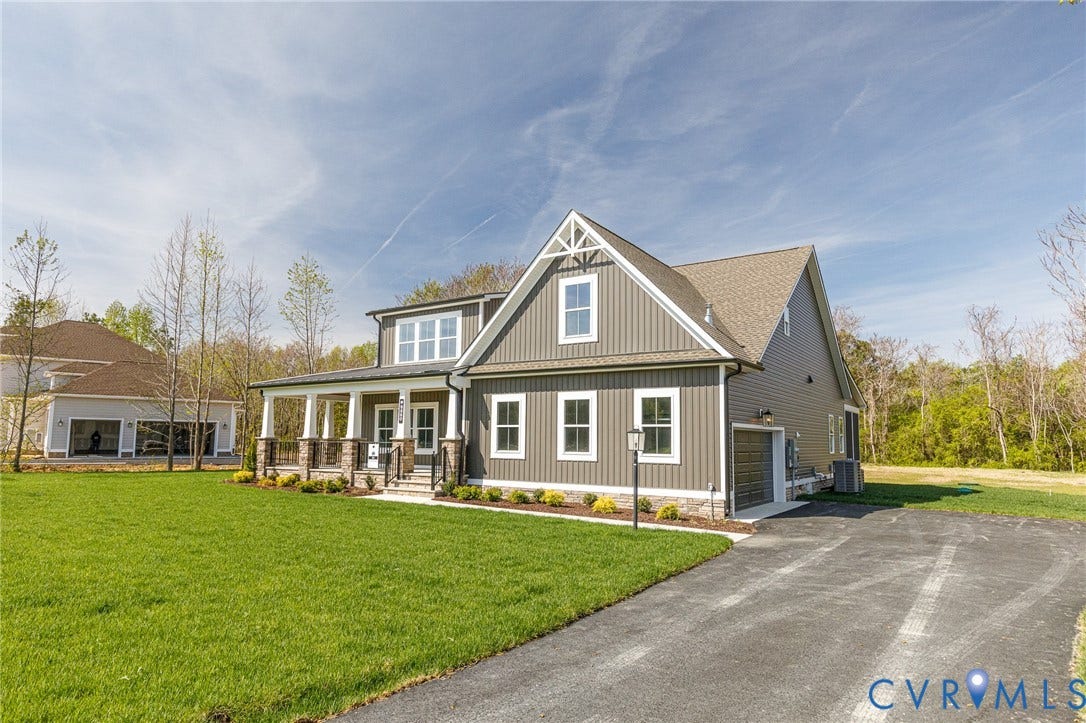 8860 Emily Jane Place, Quinton, VA 23141 The property features a well-maintained lawn, a paved driveway, and an attached garage