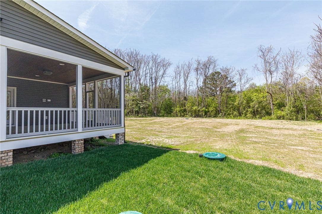 8860 Emily Jane Place, Quinton, VA 23141 The property features a screened-in porch with white railings and gray siding, supported by brick pillars