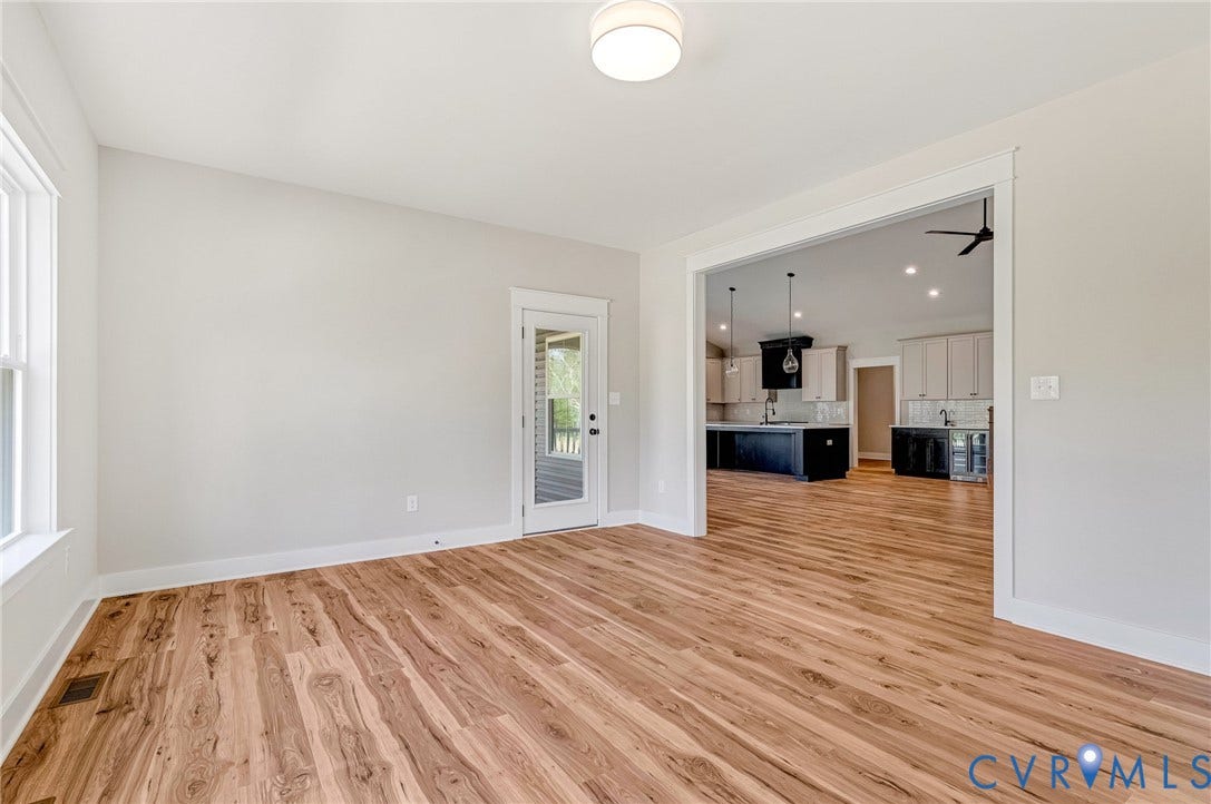 8860 Emily Jane Place, Quinton, VA 23141 This bright room features a light-colored wall, a window, and wood-style flooring