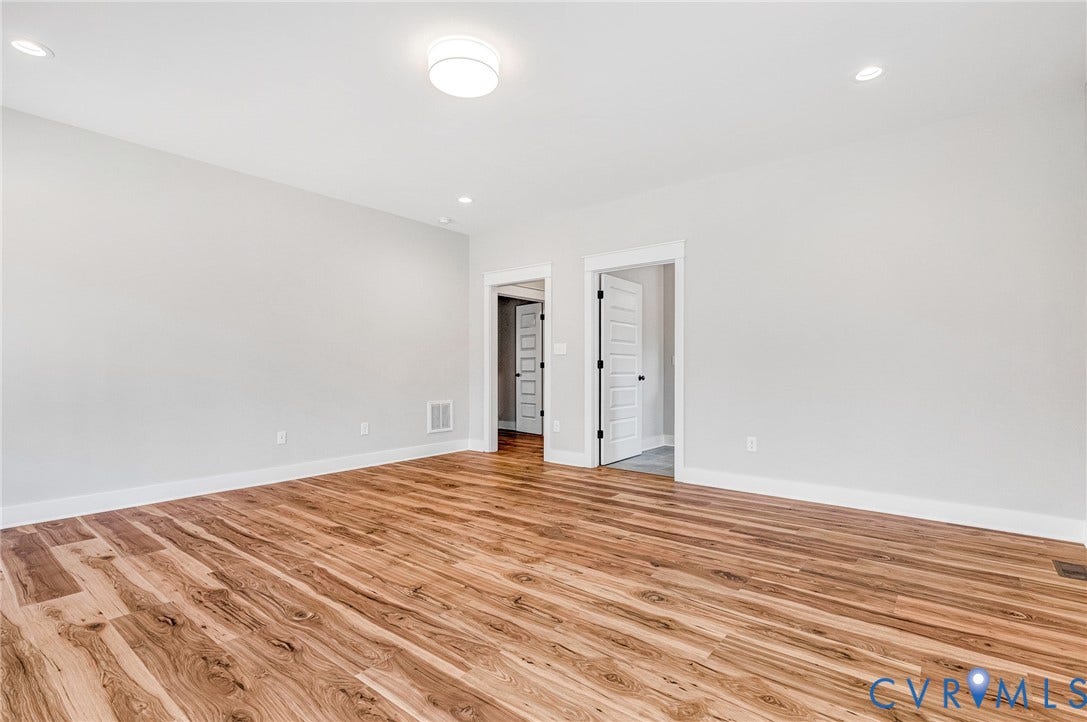 8860 Emily Jane Place, Quinton, VA 23141 This room features light-colored walls, recessed lighting, and rich wood flooring