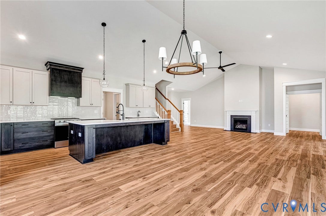 8860 Emily Jane Place, Quinton, VA 23141 The property features an open-concept living space with hardwood flooring and vaulted ceilings