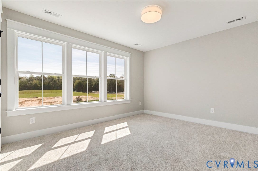 8860 Emily Jane Place, Quinton, VA 23141 This room features three large windows that provide abundant natural light and views of green fields and trees