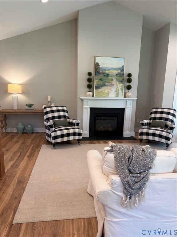8860 Emily Jane Place, Quinton, VA 23141 Living area featuring a vaulted ceiling, wood-finish flooring, a fireplace with a white mantel, and recessed lighting