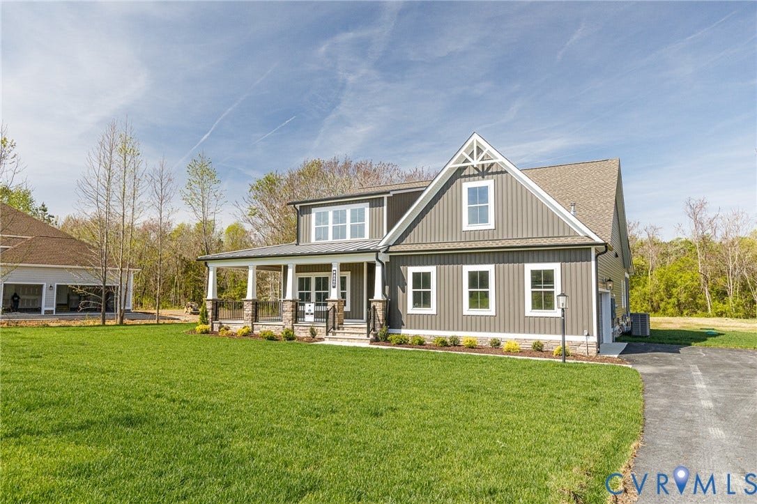 8860 Emily Jane Place, Quinton, VA 23141 The property features a well-maintained lawn and a paved driveway, leading to the home with gray siding and white trim