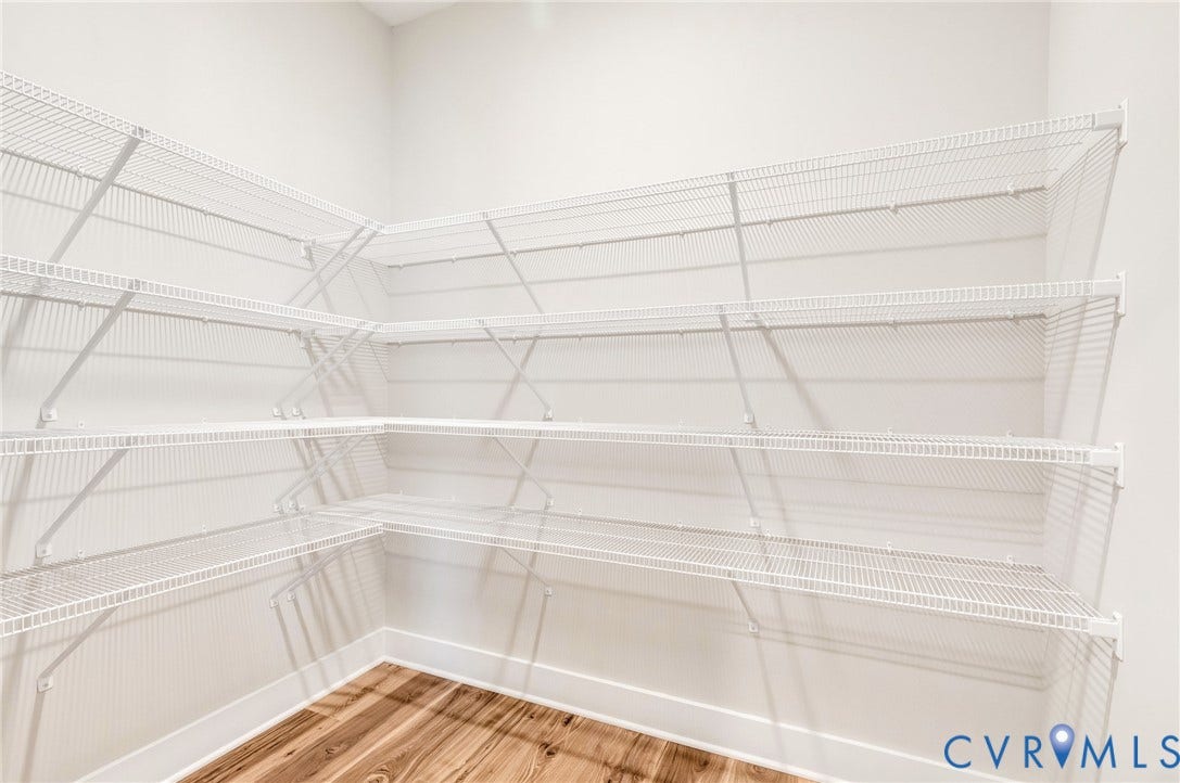 8860 Emily Jane Place, Quinton, VA 23141 This pantry features extensive white wire shelving and hardwood flooring