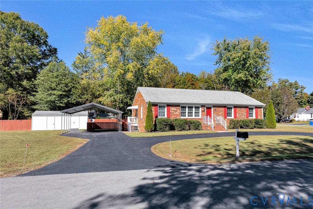 6432 Bellflower Circle, Mechicsville, Mechanicsville, VA 23111 Brick exterior residence featuring red window shutters, a paved driveway, and an attached metal-frame carport
