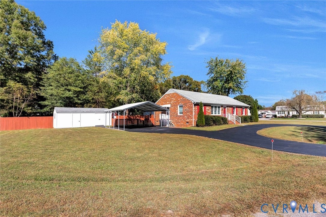 6432 Bellflower Circle, Mechicsville, Mechanicsville, VA 23111 Brick exterior featuring a metal-roofed carport, asphalt driveway, detached storage structure, and fenced grounds