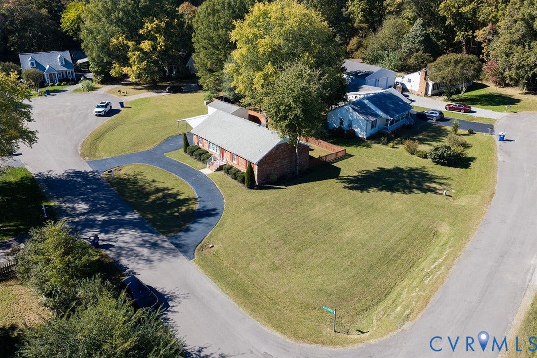 6432 Bellflower Circle, Mechicsville, Mechanicsville, VA 23111 Corner lot with an expansive lawn, brick exterior, asphalt driveway, and mature trees