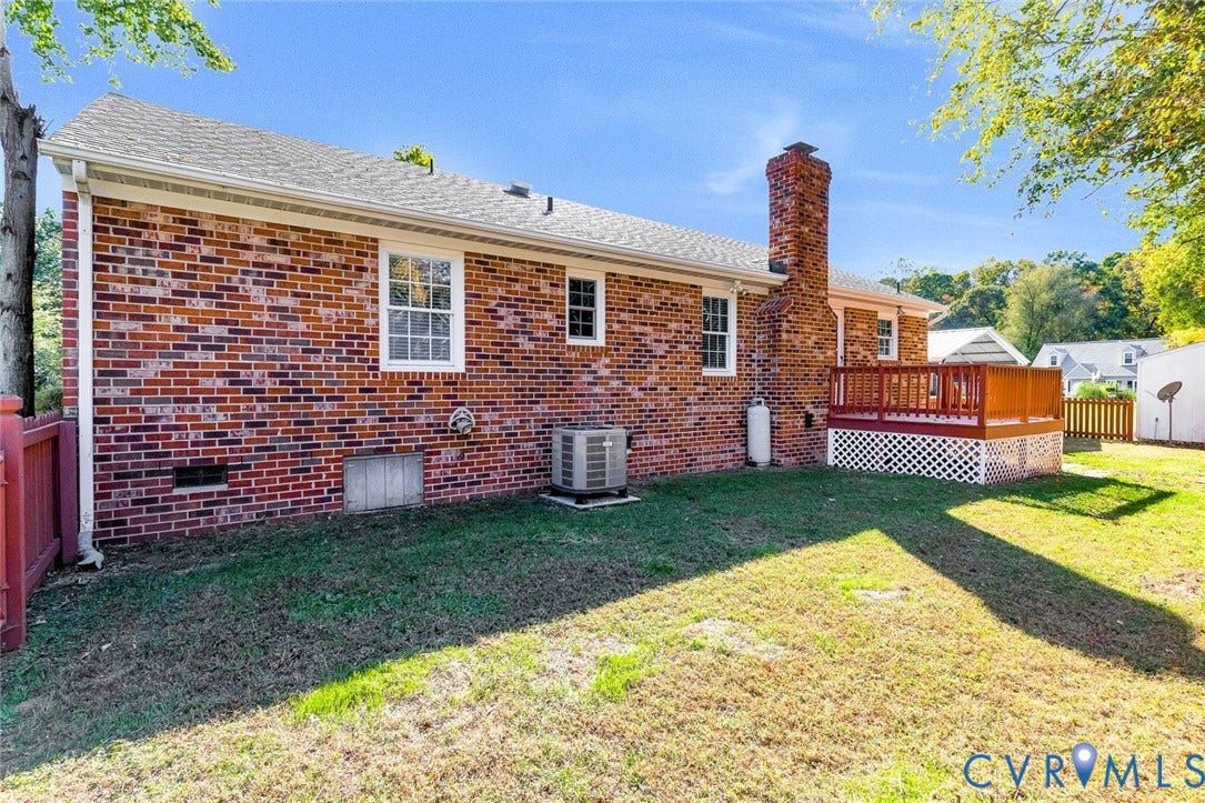 6432 Bellflower Circle, Mechicsville, Mechanicsville, VA 23111 Exterior rear elevation featuring red brick siding, a raised wood deck with lattice skirting, and a masonry chimney