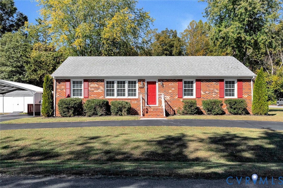 6432 Bellflower Circle, Mechicsville, Mechanicsville, VA 23111 Single-story brick exterior featuring a shingled roof, red decorative shutters, central front entryway with brick steps and railings, and an attached metal-framed carport