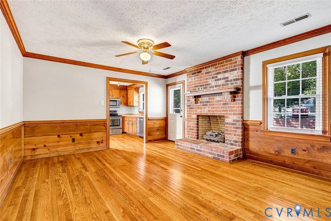 6432 Bellflower Circle, Mechicsville, Mechanicsville, VA 23111 Living area featuring wood-finish flooring, floor-to-ceiling brick fireplace with wooden mantel, wood wainscoting, and a central ceiling fan