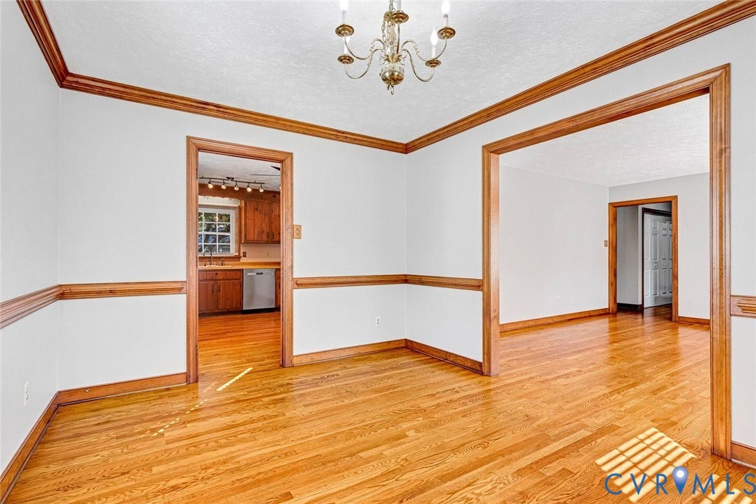 6432 Bellflower Circle, Mechicsville, Mechanicsville, VA 23111 Interior space featuring wood-finish flooring, crown molding, chair rail trim, and a multi-arm chandelier