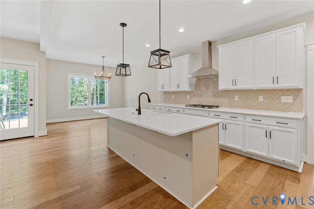 14270 Tower Road, Scotchtown Estates, Montpelier, VA 23047 Kitchen featuring white shaker-style cabinetry, quartz countertops, a central island with a matte black faucet, herringbone-patterned tile backsplash, and wood-finish flooring